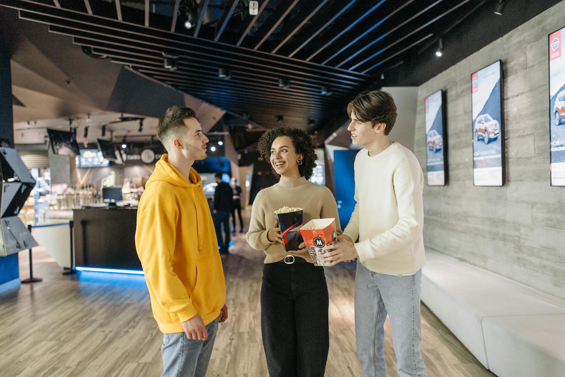 people holding popcorn chatting